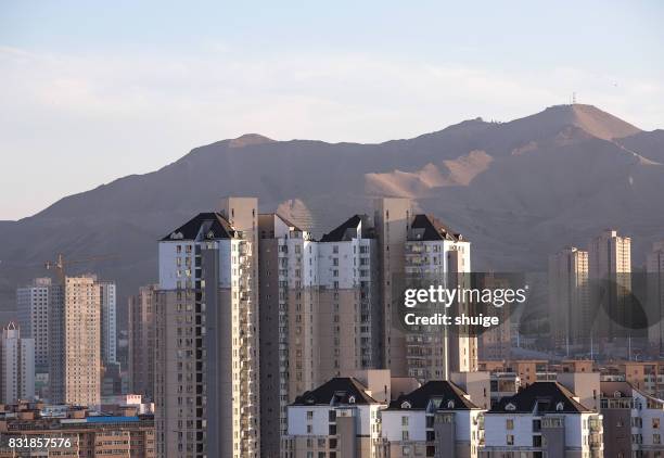 urumqi cityscape at sunset - urban skyline xinjiang stock pictures, royalty-free photos & images