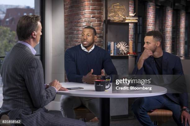 Andre Iguodala, a professional basketball player with the National Basketball Association's Golden State Warriors, center, speaks while Stephen...