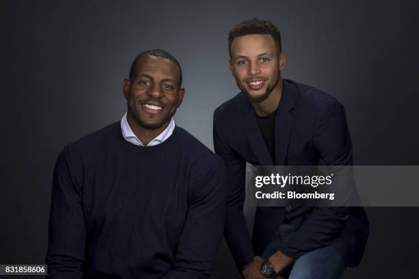 National Basketball Association's Golden State Warriors professional basketball players Andre Iguodala, left, and Stephen Curry smile for a...