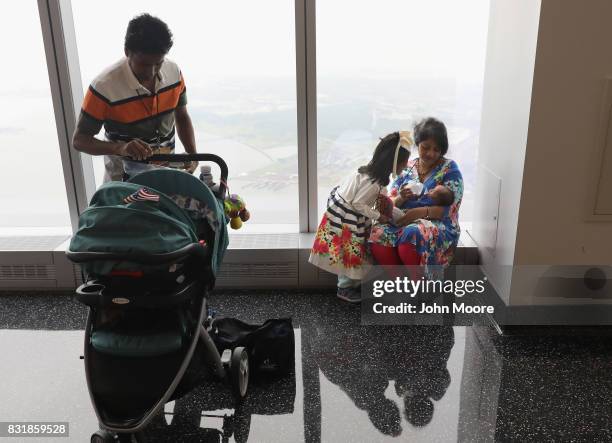Bangladeshi immigrant Khadijatul Rahman feeds her baby boy Zavyaan, 2 weeks, after becoming a U.S. Citizen at a naturalization ceremony held atop the...