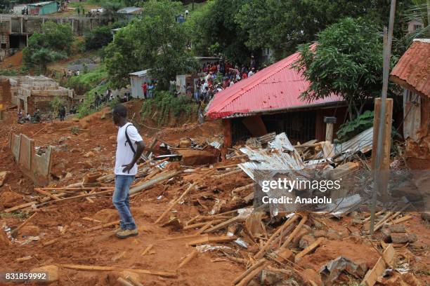 Local man is seen on a wreckage at Regent region of Freetown after landslide struck the capital of the west African state of Sierra Leone on August...