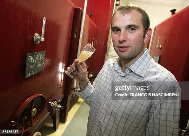 French Remy Gratiot, champagne producer, tastes a glass of "vin clair", wine from the last grape harvest, on October 9, 2008 in Charly-sur-Marne,...