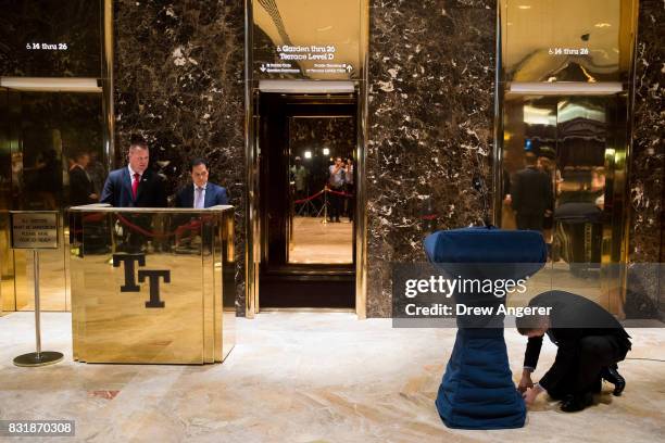 Staff members set up a podium in the lobby of Trump Tower, August 15, 2017 in New York City. On Tuesday, President Donald Trump is scheduled to have...