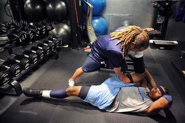 Assistant coach Steve Hess stretches Carmelo Anthony of the Denver Nuggets during practice, October 9, 2008, Pepsi Center, Denver, Colorado.