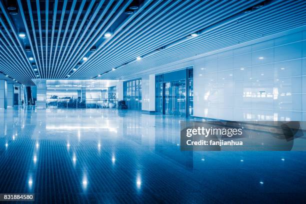 empty space in modern airport or railway station in blue tone - weltraum flughafen stock-fotos und bilder