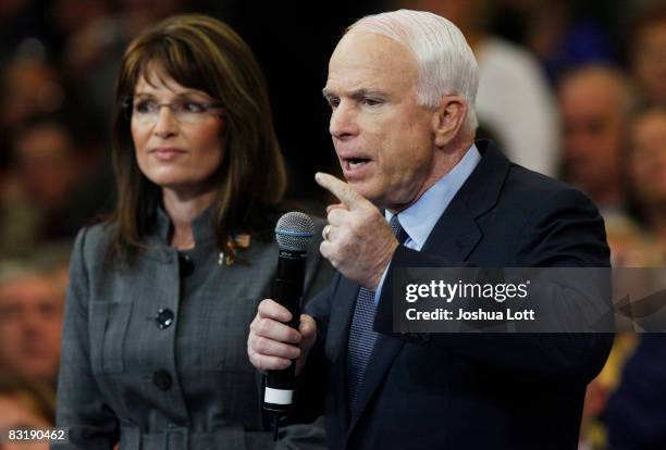 Republican presidential candidate Sen. John McCain speaks as Republican vice-presidential candidate Alaska Gov. Sarah Palin listens during a town...