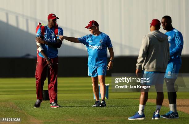 Jason Holder of West Indies chats with head coach Stuart Law during a nets session at Edgbaston on August 15, 2017 in Birmingham, England.