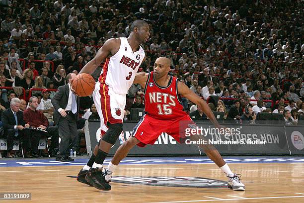 Dwyane Wade of the Miami Heat is guarded by Vince Carter of the New Jersey Nets during the NBA preseson game as part of the 2008 NBA Europe Live Tour...