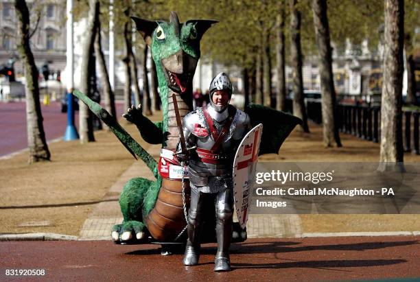 Lloyd Scott, the last finisher in this year's London Marathon, takes his final steps towards the finishing line on The Mall, London, wearing a suit...