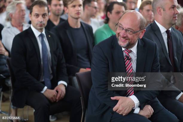 Martin Schulz, Social Democrat Party candidate for German Chancellor, second right, smiles before delivering a speech on refugees and integration in...