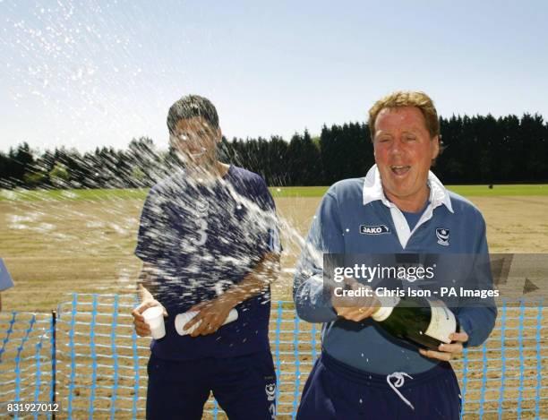 Portsmouth manager Harry Redknapp sprays the champagne as captain Dejan Stefanovic looks on at the club's training ground near Southampton.