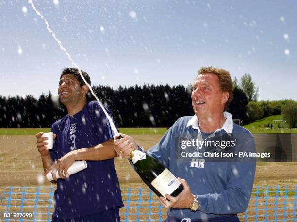 Portsmouth manager Harry Redknapp sprays the champagne as captain Dejan Stefanovic looks on at the club's training ground near Southampton.