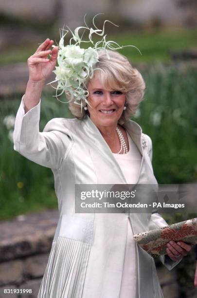 The Duchess of Cornwall waves to the crowd as she arrives at St Cyriac's Church in Lacock, Wiltshire, for the wedding of her daughter Laura Parker...