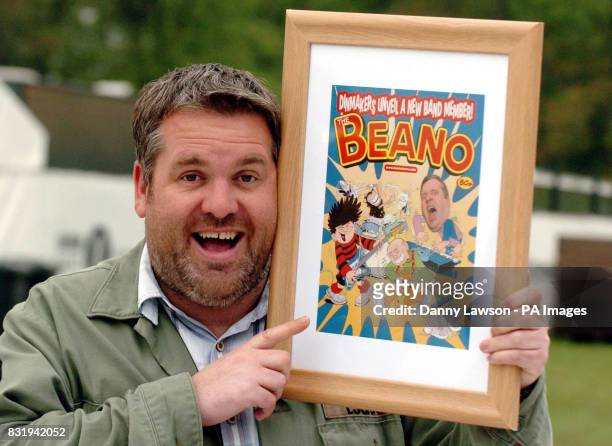 Chris Moyles, host of Radio 1's Breakfast Show, with a special print of a Beano front cover featuring himself, Dennis, and Gnasher. The artwork was...