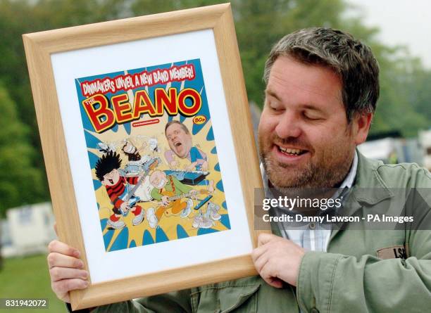 Chris Moyles, host of Radio 1's Breakfast Show, with a special print of a Beano front cover featuring himself, Dennis, and Gnasher. The artwork was...