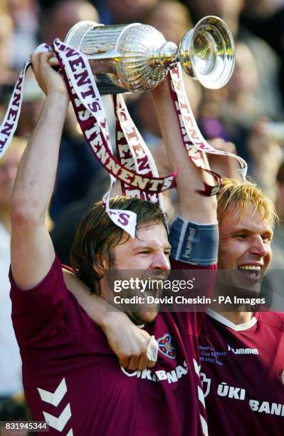 Hearts' Steven Pressley lifts the Tennentss Scottish Cup with Edgaras Janjauskas after defeating Gretna 4-2 on penalties in the Tennents Scottish Cup...