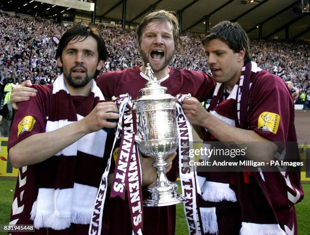 Previously unissued photo dated of Hearts' Paul Hartley Steven Pressley and Takis Fyssas celebrate with the trophy after winning the Tennents...