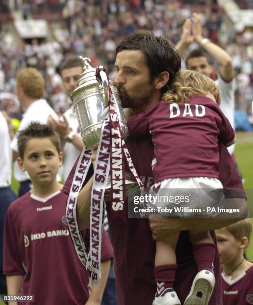 Hearts player Paul Hartley kisses the cup in Tynecastle Stadium after the team paraded through Edinburgh's Royal Mile to celebrate yesterday's...