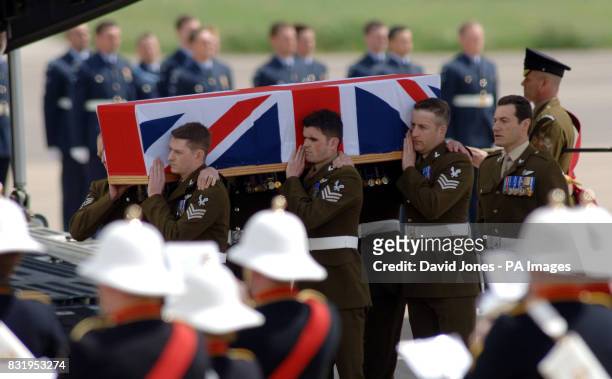 The coffin of Captain David Dobson of the Army Air Corps is carried from a C-17 Globemaster transport plane at RAF Brize Norton in Oxfordshire.