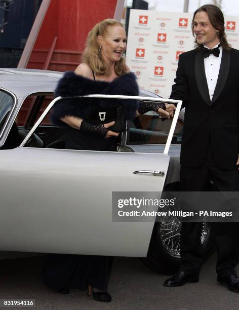 Ursula Andress is helped from car from son Dimitri Hamlin after arriving in the original James Bond Aston Martin DB5 from "Goldfinger" at the Royal...