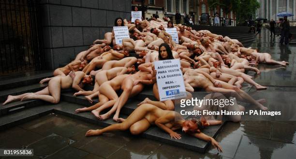 Supporters of Peta, the anti-fur campaigners, hold a naked 'die-in' protest wearing only bear masks and holding signs in various languages...