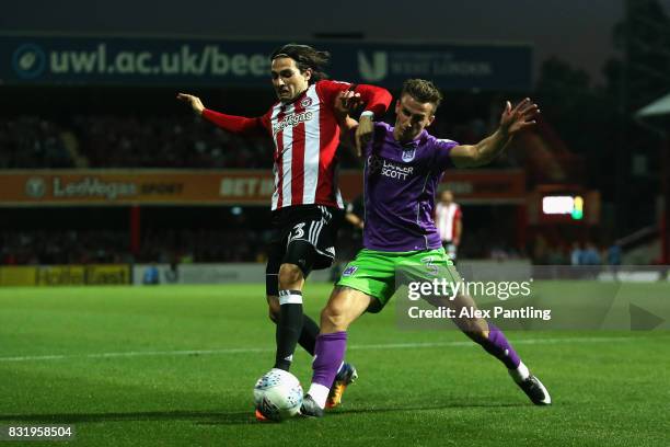 Jota of Brentford is tackled by Joe Bryan of Bristol City during the Sky Bet Championship match between Brentford and Bristol City at Griffin Park on...