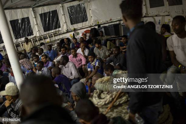 Migrants rest on the deck of the Aquarius rescue ship run by NGO SOS Mediterranee and Medecins Sans Frontieres after their transfer from the NGO...