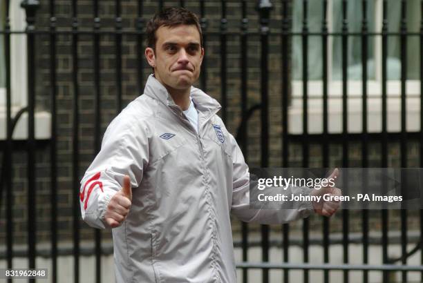 Robbie Williams leaves with the England Soccer Aid team after a reception at No. 10 Downing Street, London.