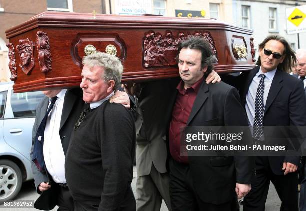 The coffin of Richard McIkenny is carried by Gerry Hunter, Gerry Conlon and Paul Hill from St Patrick's Church in Celbridge, Co Kildare, to burial,...