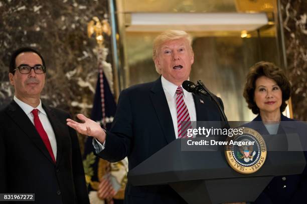 Flanked by Secretary of Treasury Steve Mnuchin and Transportation Secretary Elaine Chao, US President Donald Trump delivers remarks following a...