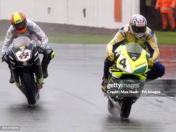 Brazil's Alex Barros on his Honda and Italy's Roberto Rolfo on his Ducati during a practice session ahead of the World Superbikes Championship at...