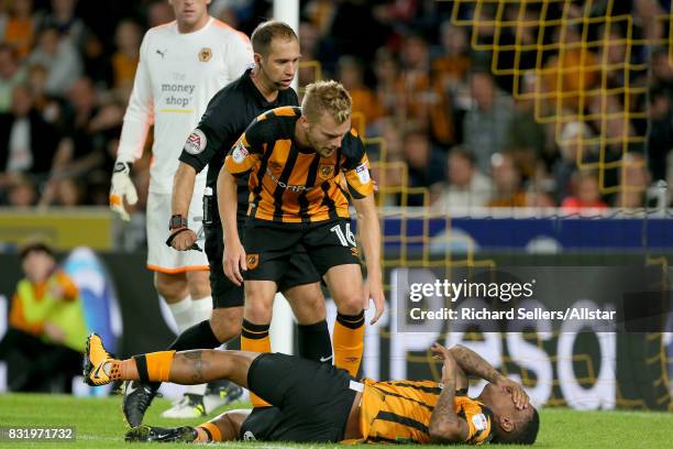 Abel Hernandez of Hull City lies in agony as Hull City's Seb Larsson cares during the Sky Bet Championship match between Hull City and Wolverhampton...