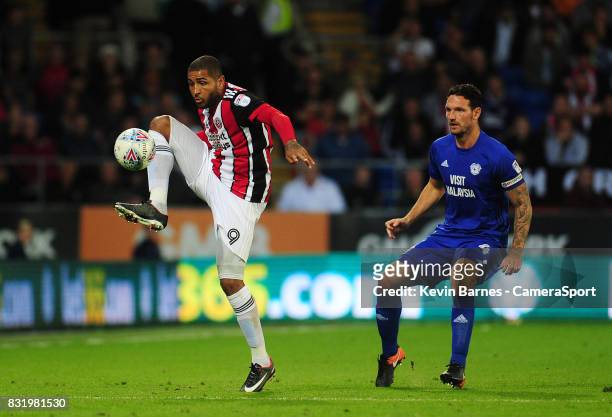 Sheffield United's Leon Clarke under pressure from Cardiff City's Sean Morrison during the Sky Bet Championship match between Cardiff City and...