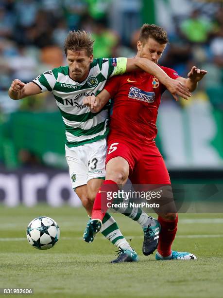 Sporting's midfielder Adrien Silva vies for the ball with Steaua's midfielder Mihai Pintilii during Champions League 2017/18, first playoff round...