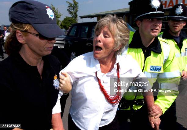 Police arrest veteran peace campaigner Lindis Percy after she shouted questions at the former US President George Bush Senior as he arrived to...
