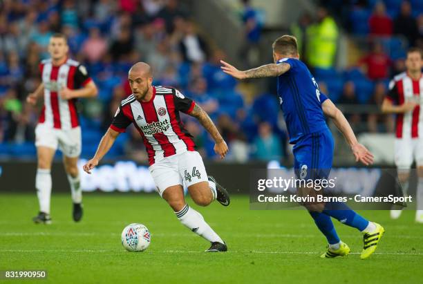 Sheffield United's Samir Carruthers under pressure from Cardiff City's Joe Ralls during the Sky Bet Championship match between Cardiff City and...