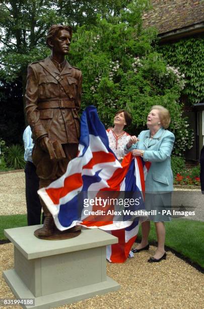 Lady Thatcher unveils a statue of World War One poet Rupert Brooke at Lord Archer's home in Grantchester, near Cambridge whille Lady Archer looks on.