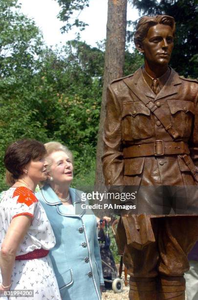Lady Thatcher and Lady Archer admire a statue of World War One poet Rupert Brooke after its unveiling at Lord Archer's home in Grantchester, near...