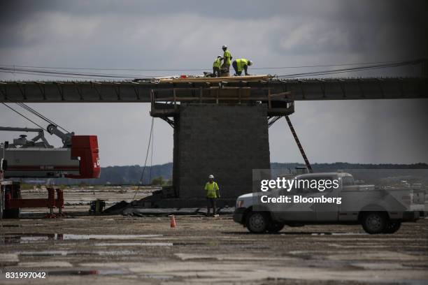 Contractors work on the construction site of the American Mobility Center in Ypsilanti, Michigan, U.S., on Tuesday, Aug. 15, 2017. Representative...