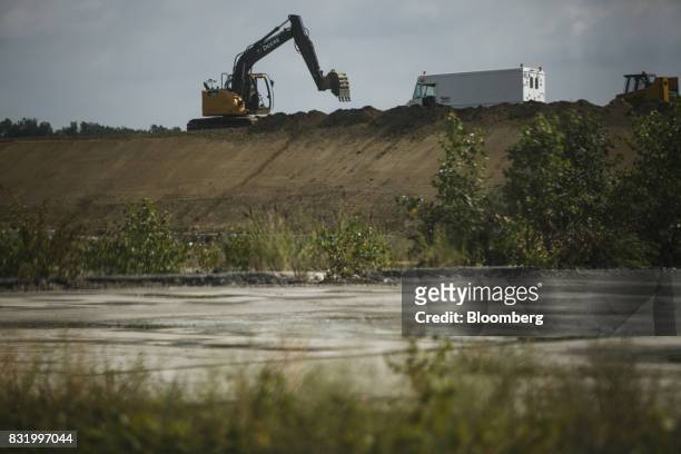 Deere & Co. Excavator move dirt on the construction site of the American Mobility Center in Ypsilanti, Michigan, U.S., on Tuesday, Aug. 15, 2017....