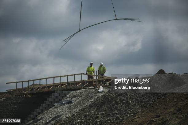 Contractors work on the construction site of the American Mobility Center in Ypsilanti, Michigan, U.S., on Tuesday, Aug. 15, 2017. Representative...