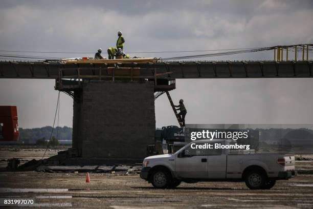 Contractors work on the construction site of the American Mobility Center in Ypsilanti, Michigan, U.S., on Tuesday, Aug. 15, 2017. Representative...