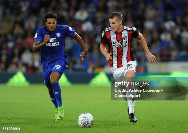 Sheffield United's Paul Coutts vies for possession with Cardiff City's Nathaniel Mendez-Laing during the Sky Bet Championship match between Cardiff...