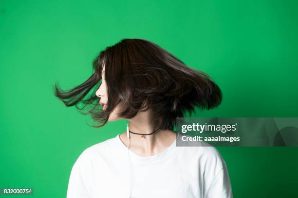 young girl against green background in studio - girl short hair stock pictures, royalty-free photos & images