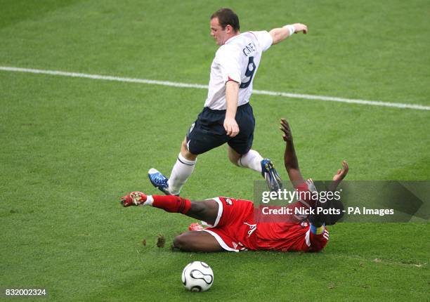 England's Wayne Rooney skips the challenge of Trinidad and Tobago's Dwight Yorke.