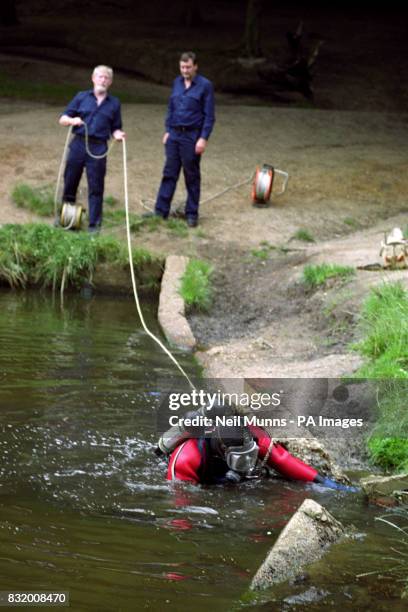 Police divers search Queens Mere pond on Wimbledon Common in their hunt for the weapon used in the murder of young mother Rachel Nickell.