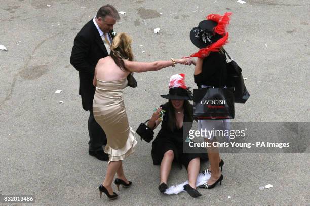 Racegoers leave the Royal Ascot race meeting, in Berkshire, at the end of Ladies' Day.