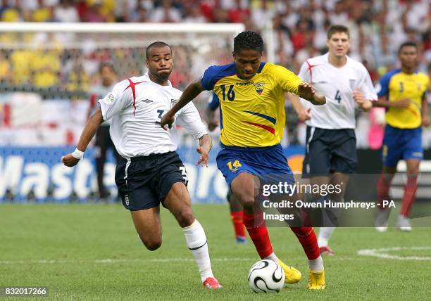 Ecuador's Luis Valencia pulls away from England's Ashley Cole
