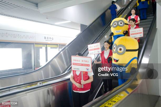 Volunteer dressed as Minions character greets members of the public at the Wuhan Metro line 3 on August 13, 2017 in Wuhan, Hubei Province of China....
