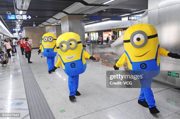 Volunteer dressed as Minions character greets members of the public at the Wuhan Metro line 3 on August 13, 2017 in Wuhan, Hubei Province of China....